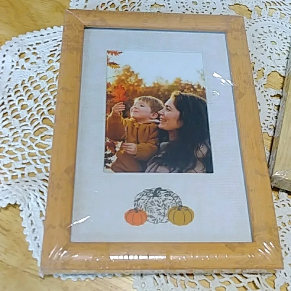 Three small picture frames, new in plastic